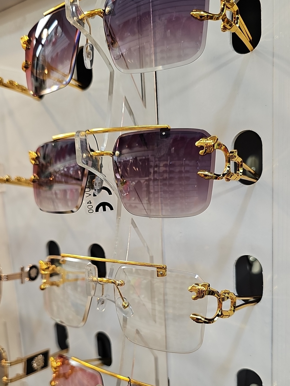 Gold-Accent Rimless Sunglasses with Purple Gradient Lenses